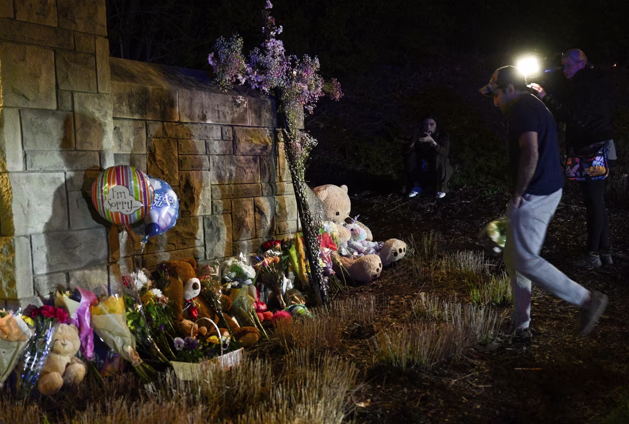 A person places flowers at a makeshift memorial outside the Covenant School in Nashville, Tennessee, on March 27. 