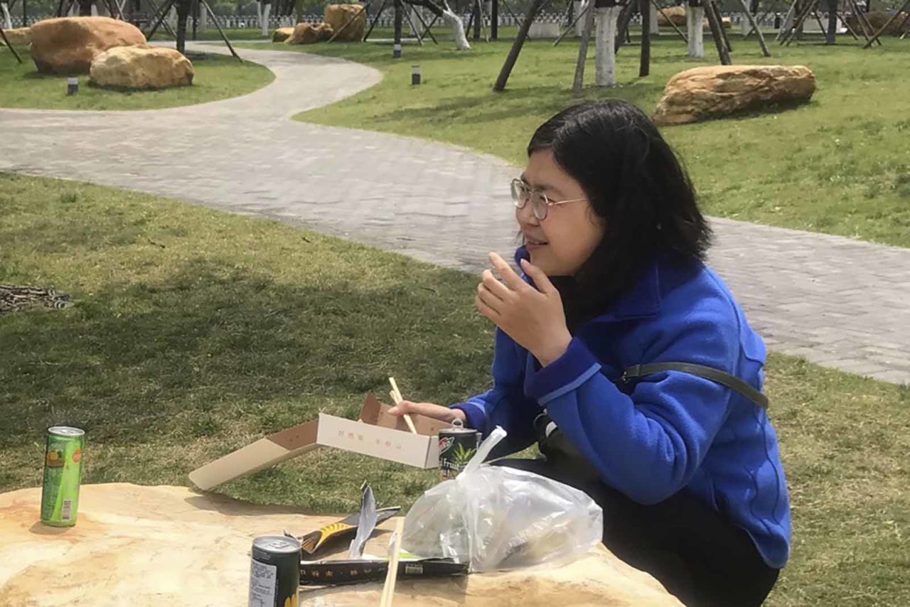 In this photo taken April 14, Zhang Zhan eats a meal at a park during a visit to Wuhan in China's Hubei province.