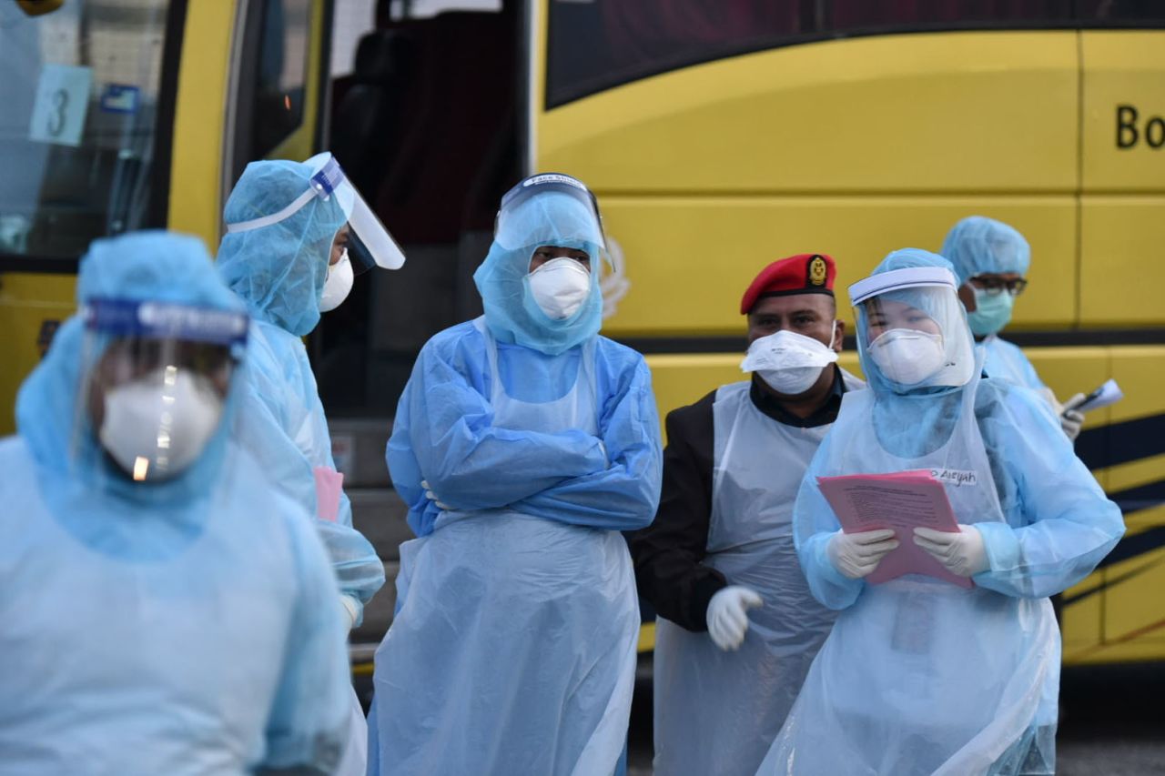 This handout released?by Malaysia's Ministry of Health shows health officials wearing protective suits at the Kuala Lumpur International Airport in Malaysia on Tuesday.