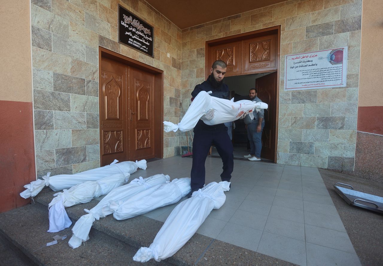 A man carries a body of a Palestinian killed in Israeli strikes on Al-Mawasi, according to a health ministry official, at a hospital in Khan Younis, Gaza, on January 4.