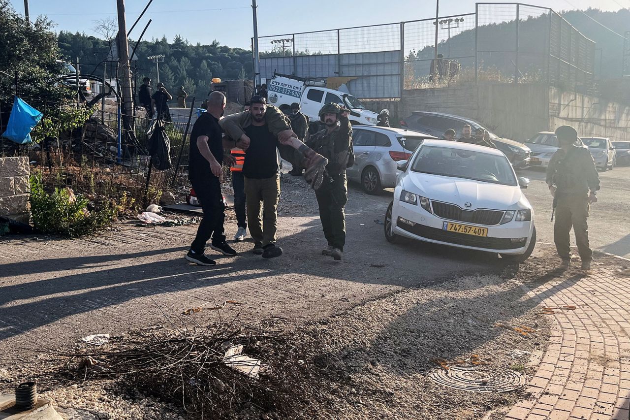 An Israeli soldier carries an injured comrade after projectiles were fired from Lebanon towards Israel, in Hurfeish, Israel, on Wednesday, June 5.