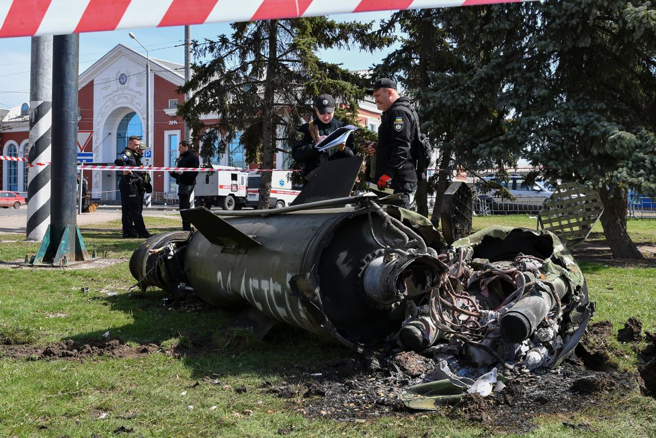 Ukrainian servicemen stand next to a fragment of a Tochka-U missile after Russian shelling at the railway station in Kramatorsk, Ukraine, on Friday, April 8.