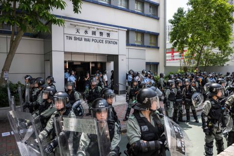 Riot police stand guard outside the Tin Shui Wai police station during a protest on August 5, 2019 in Hong Kong.