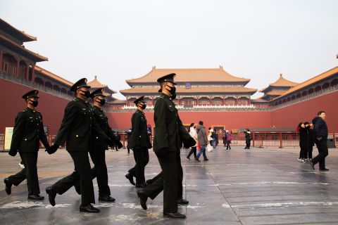 Chinese police officers walk in front of the gated entrance of The Palace Museum on January 26, in Beijing, China. 