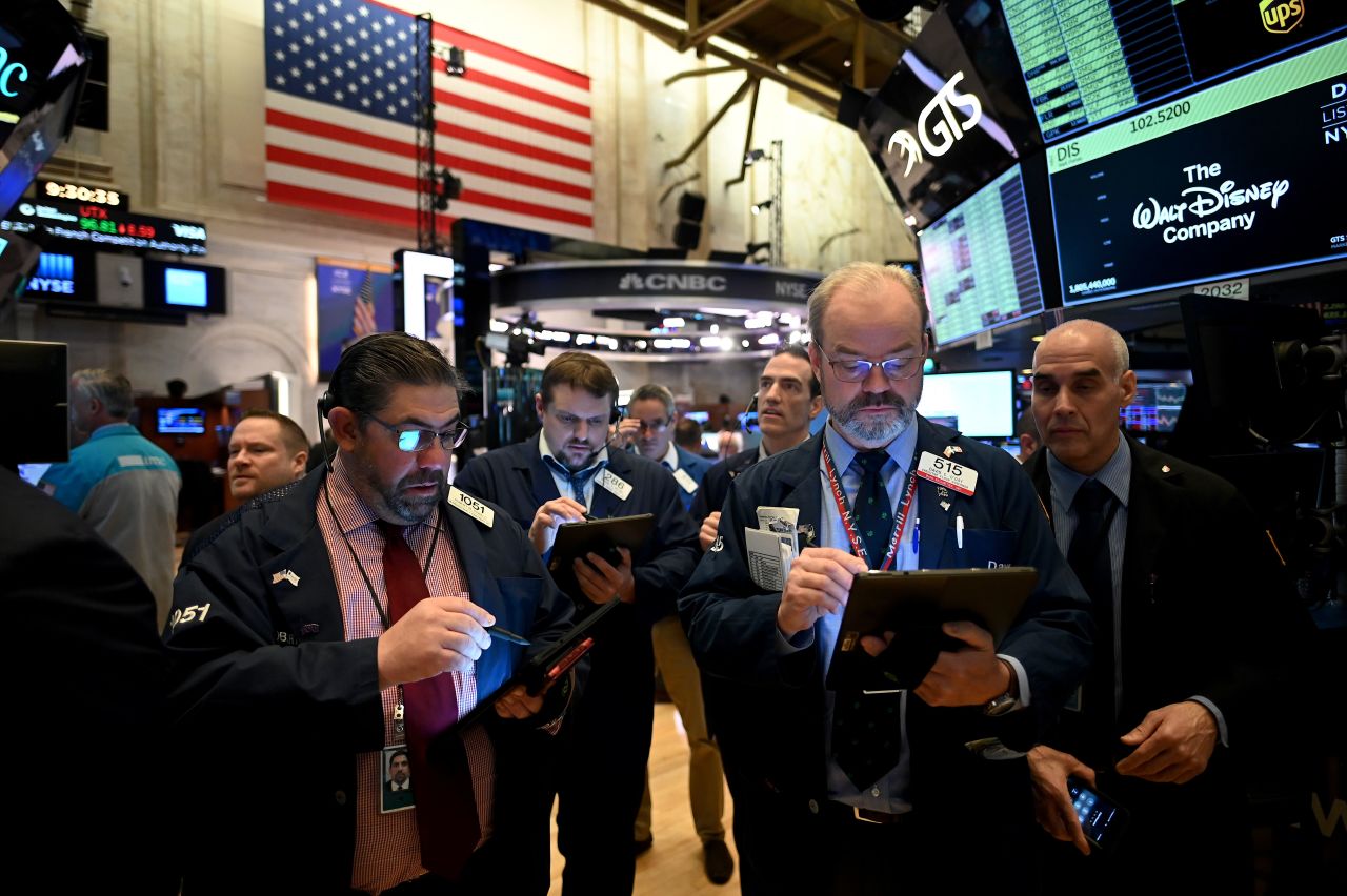 Traders work during the opening bell at the New York Stock Exchange (NYSE) on Monday, March 16.