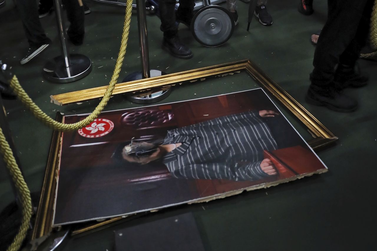 A damaged portrait of former legislative leader lie on the ground after protesters broke into the Legislative Council building in Hong Kong, Monday, July 1.