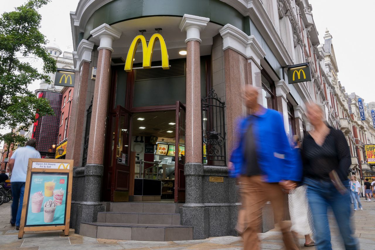 People walk past a McDonald's in London in July.