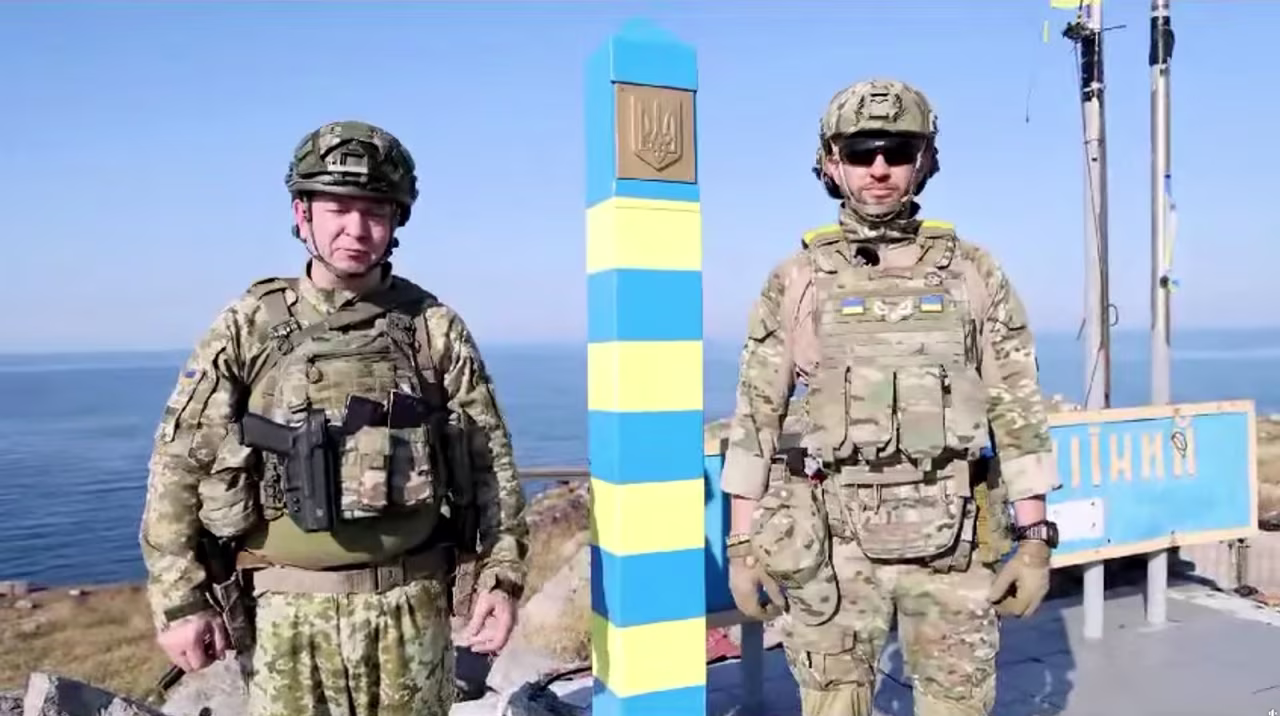 Ukrainian border guards stand next to a newly installed border sign on Snake Island in this screengrab from social media video released on August 12. 