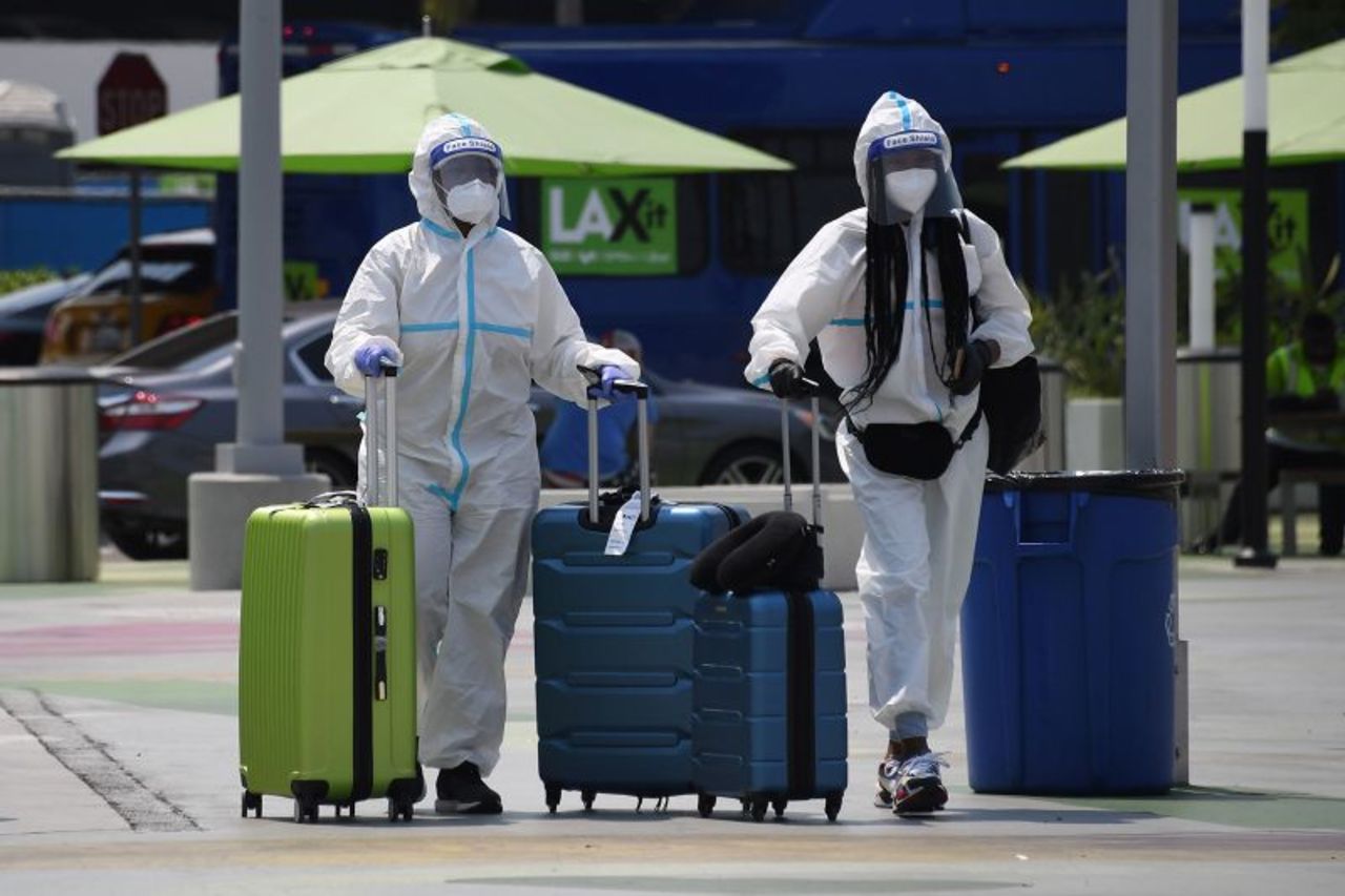 Travelers walk to the ride-share area of Los Angeles International Airport on August 20.