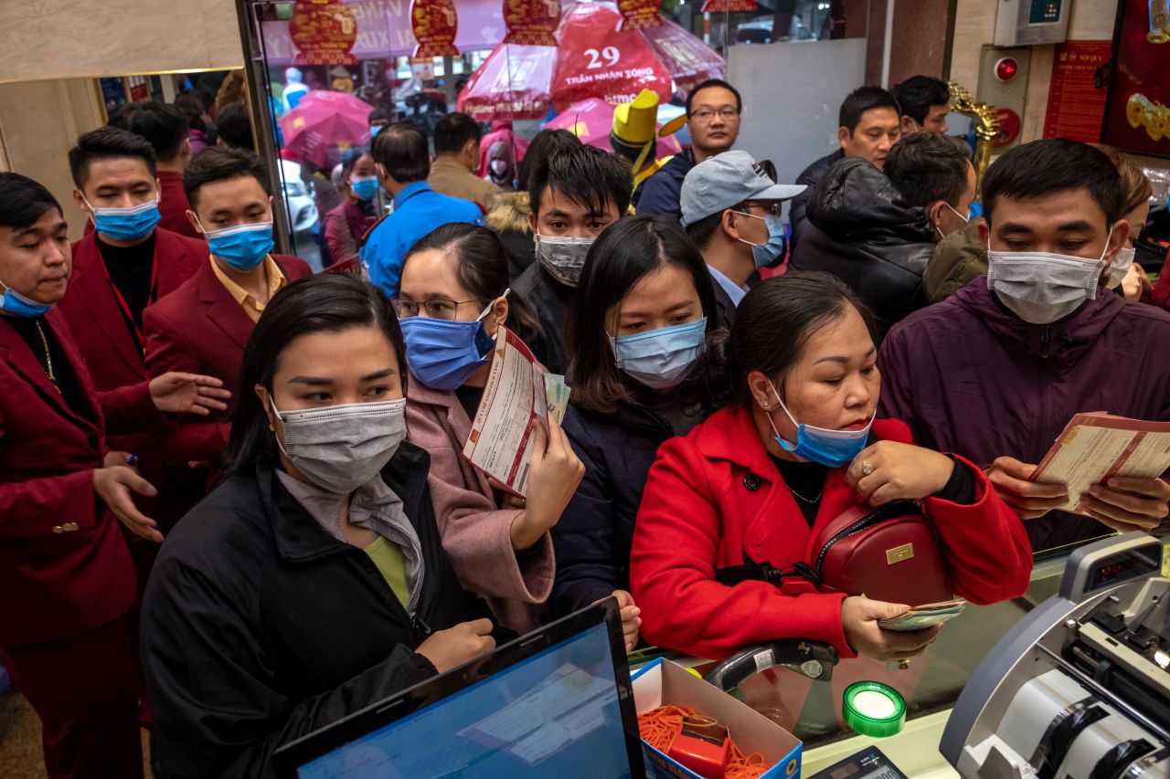 People wear face masks at a gold shop on February 3, 2020 in Hanoi, Vietnam. 