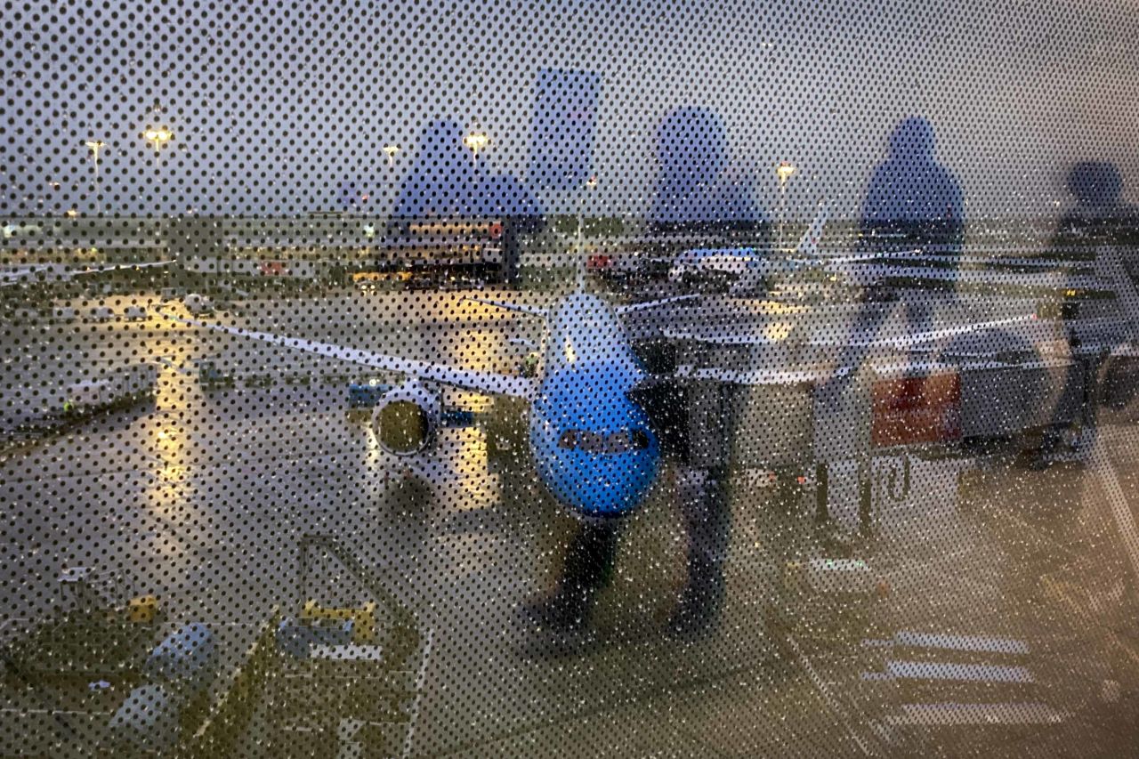 Arriving passengers are reflected in a screened window at the airport in Amsterdam, Netherlands, on December 24. 