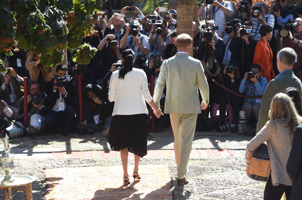 Prince Harry and Meghan, Duchess of Sussex, view the media as they walk through the Andalusian Gardens in Rabat, Morocco on February 25, 2019.