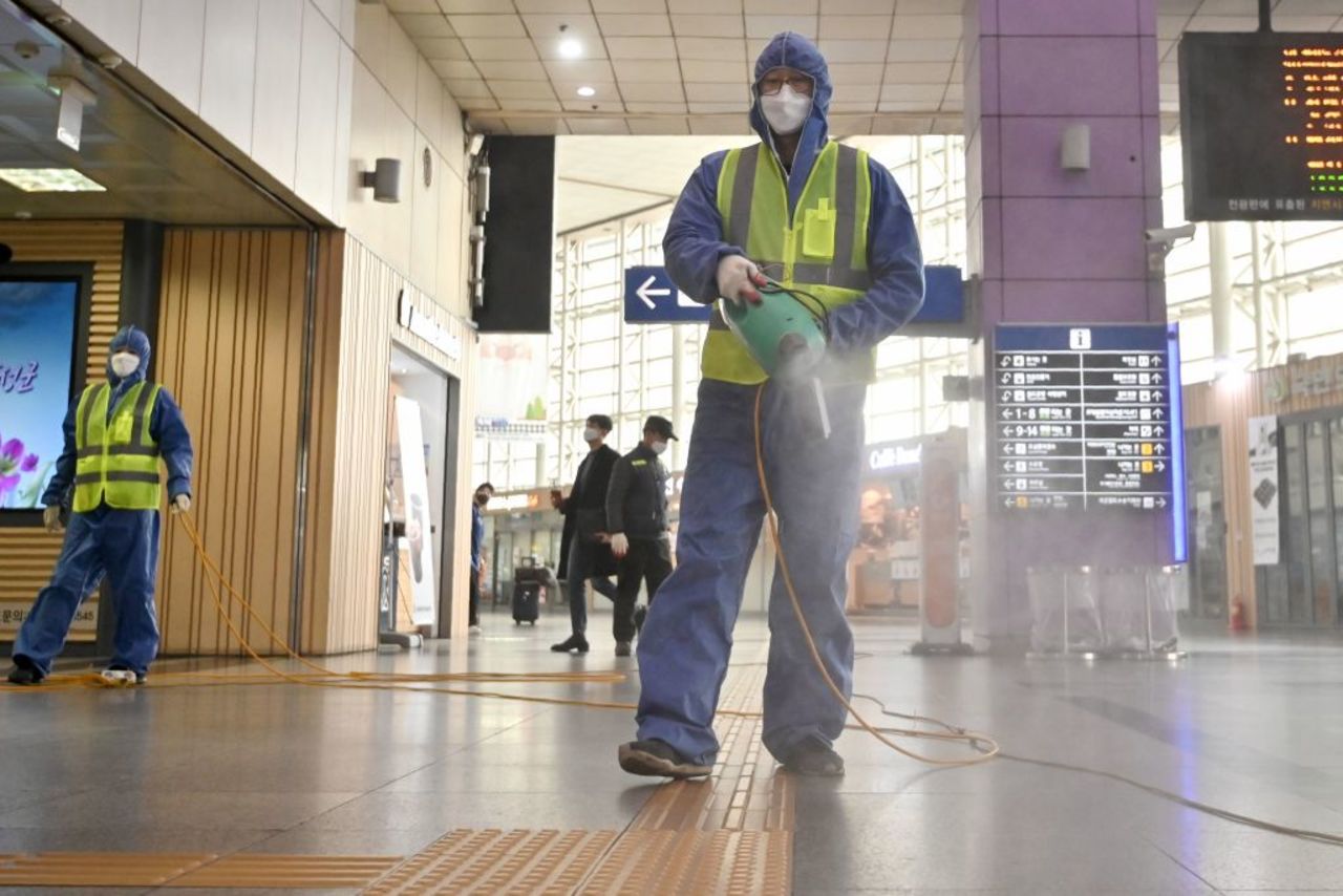 A worker  sprays disinfectant at a railway station in Daegu, South Korea, on February 26.