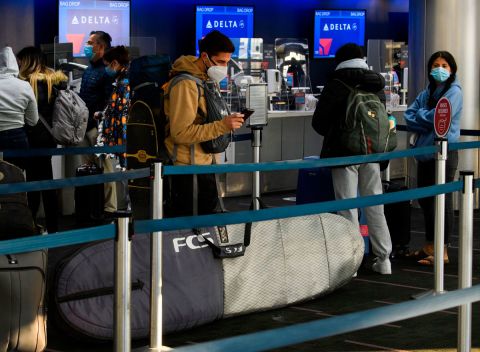 Passengers wait in line to check-in for Delta Air Lines flights at Los Angeles International Airport ahead of the Thanksgiving holiday in Los Angeles, California, November 25.
