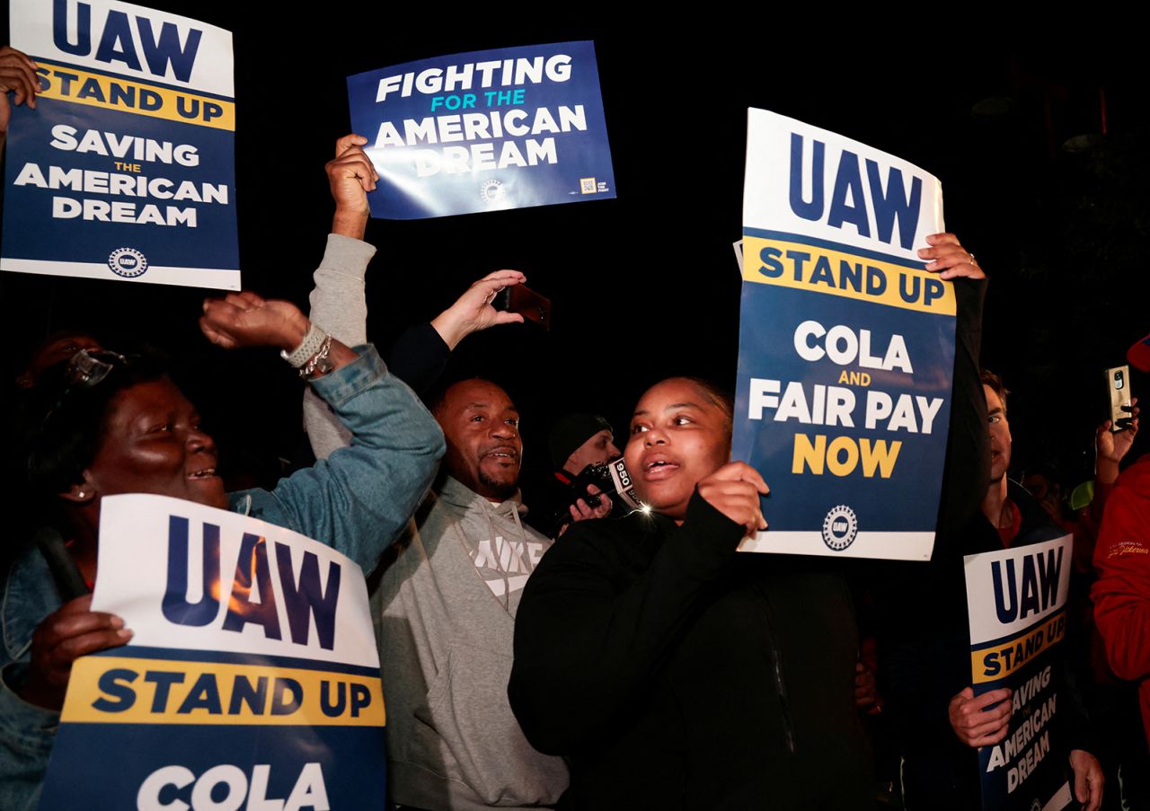 United Auto Workers hold up strike signs right across from the Ford Michigan Assembly Plant in Wayne, Michigan, on September 15.