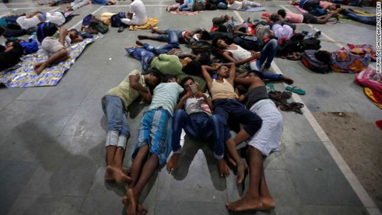 Stranded passengers rest inside a railway station after trains between Kolkata and Odisha were cancelled ahead of Cyclone Fani, in Kolkata, India on May 3.