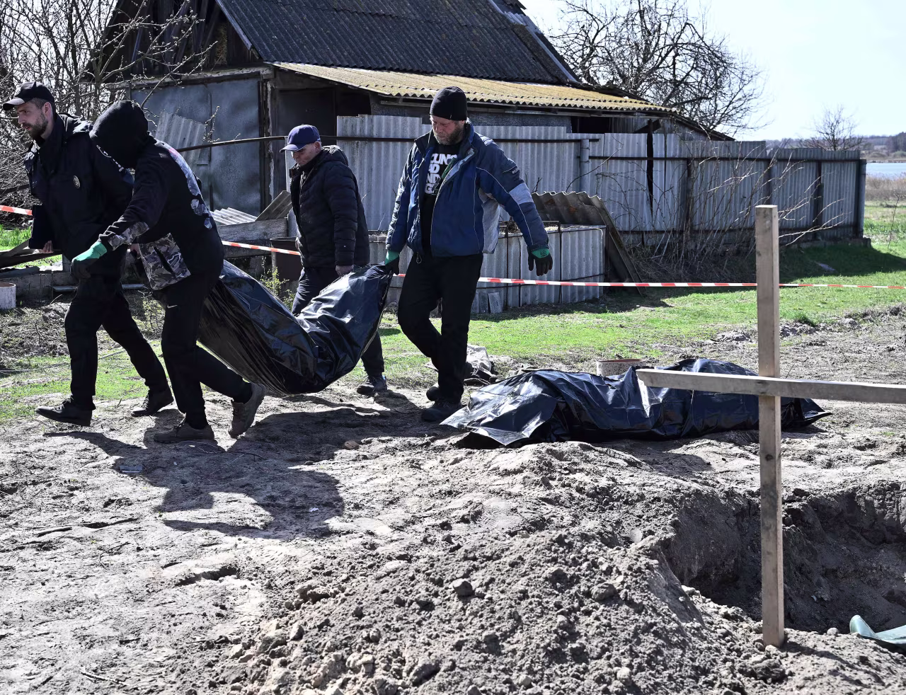 Workers exhume two bodies from graves in the village of Vablia, Kyiv region on April 14.