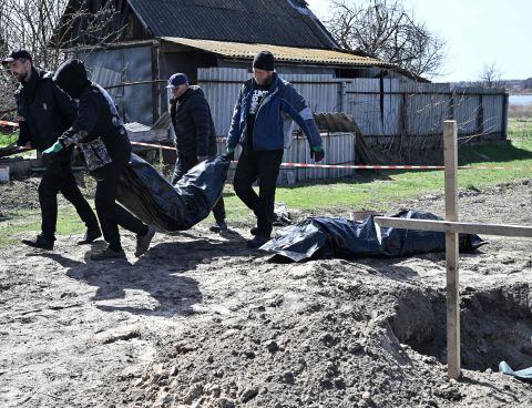 Workers exhume two bodies from graves in the village of Vablia, Kyiv region on April 14.
