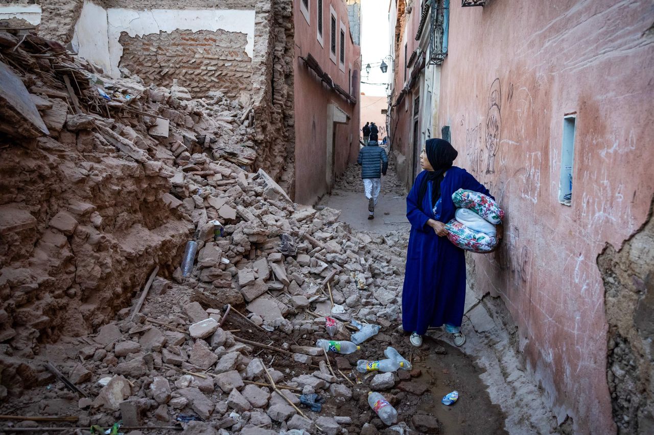 A woman looks at the rubble of a building in the earthquake-damaged old city in Marrakesh on September 9.