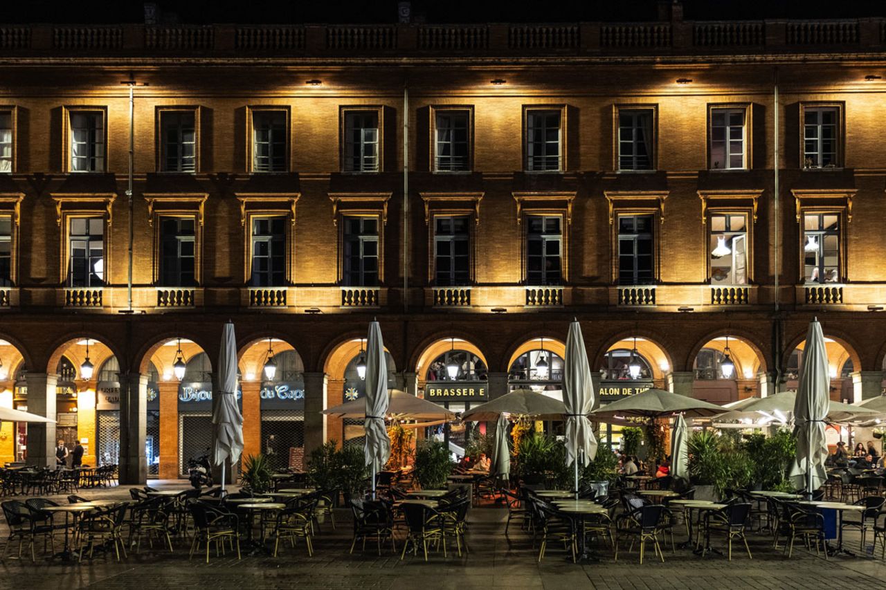 Street lights illuminate vacant tables and chairs on a restaurant terrace ahead of a curfew in Toulouse, France, on October 19.