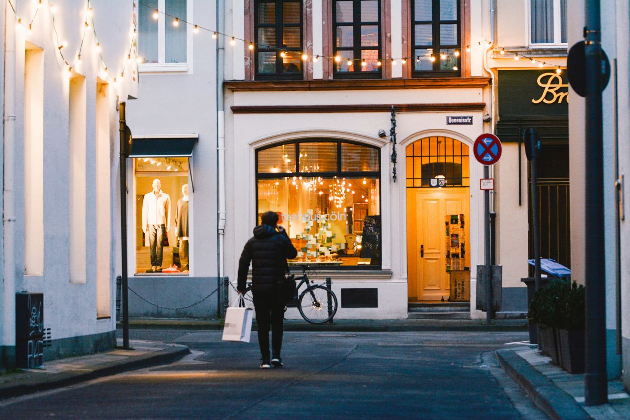 A shopper walks in a nearly empty street in Cologne, Germany on January 5, 2021. 