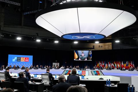 Ukraine's President Volodymyr Zelensky appears on a giant screen as he delivers a statement at the start of the first plenary session of the NATO summit at the Ifema congress centre in Madrid, on June 29.