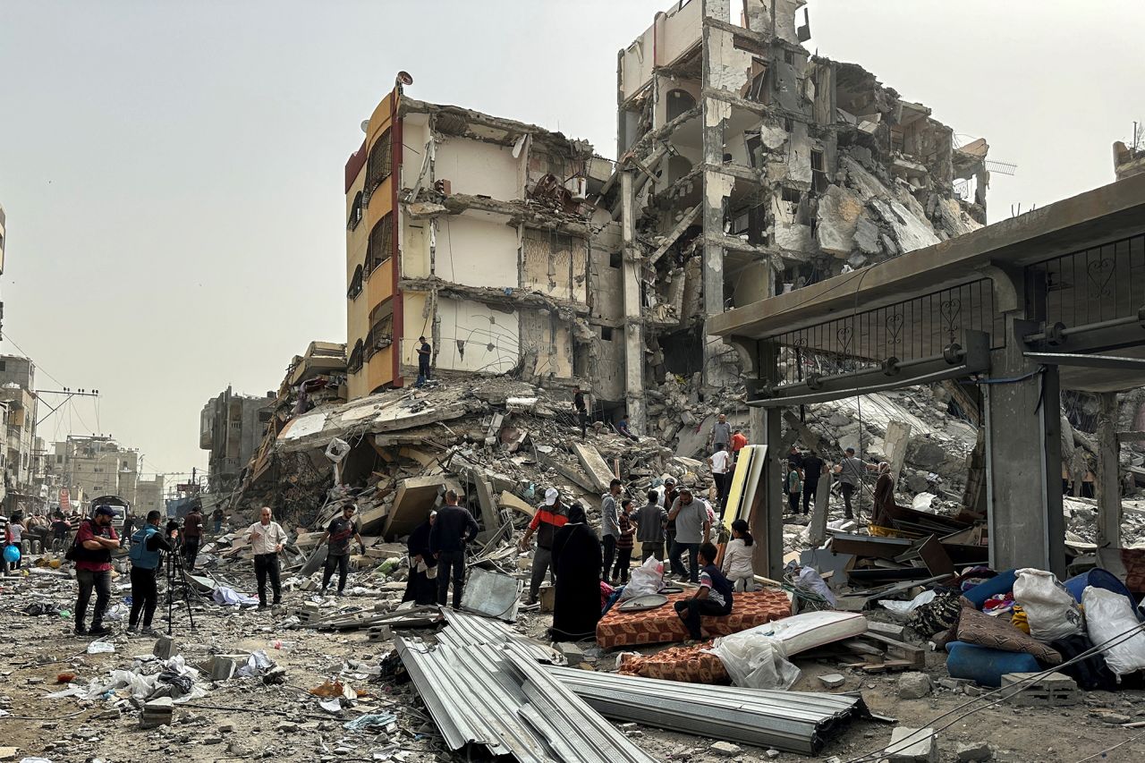 Palestinians gather around residential buildings destroyed during an Israeli raid in Nuseirat, Gaza, on April 18.