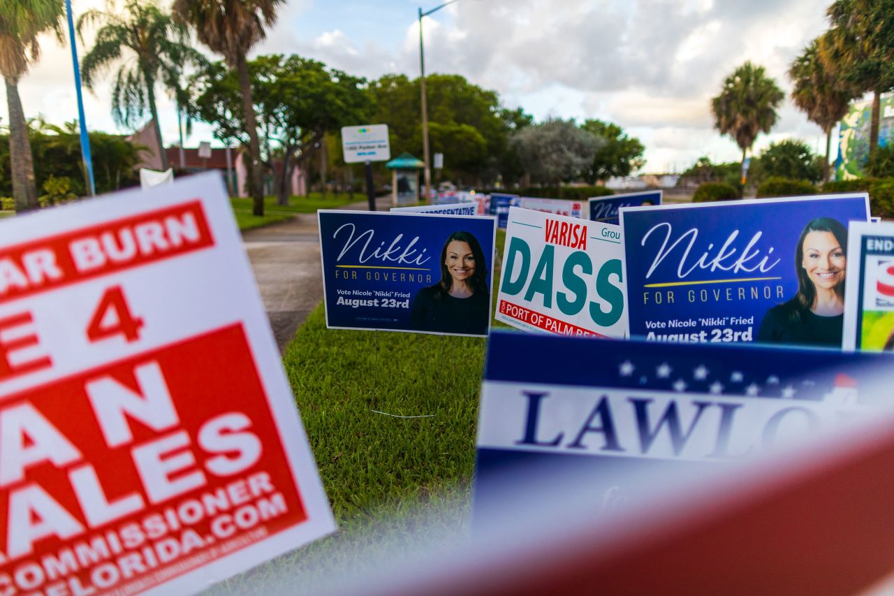 Campaign signs are seen outside of a polling station in West Palm Beach, Florida, on Tuesday.