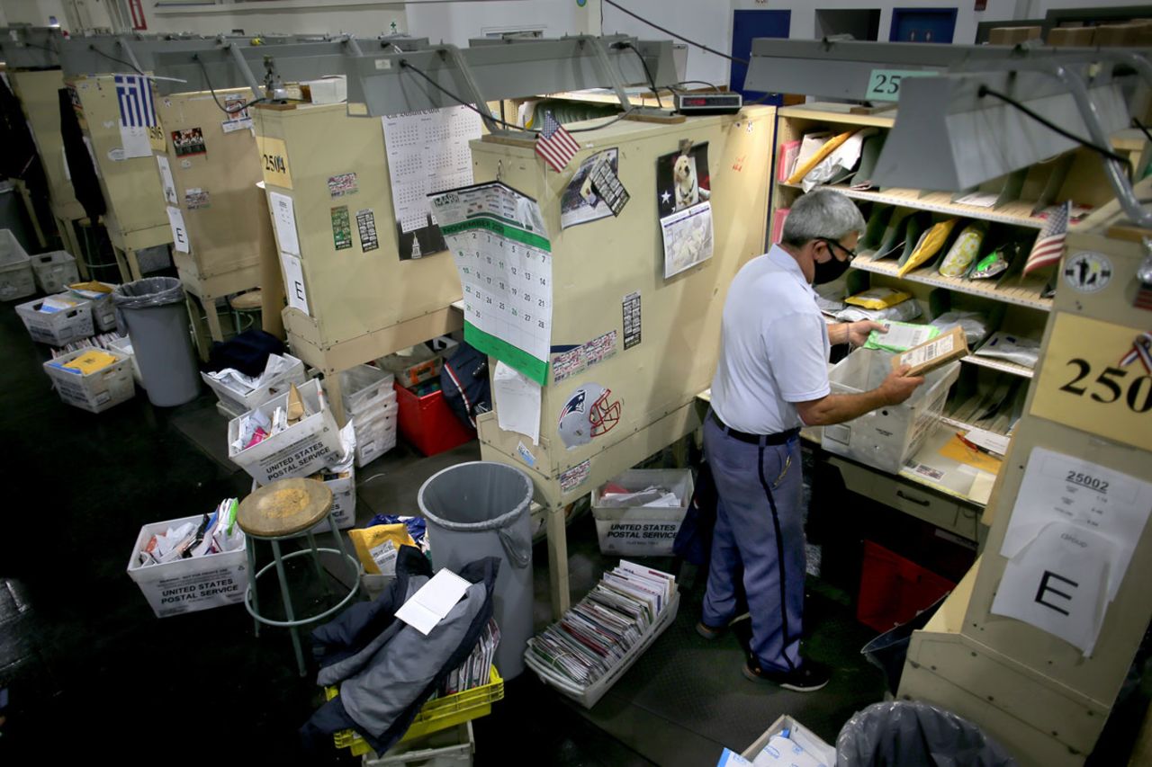 A letter carrier sorts mail at his station inside the Roxbury Post Office in Boston, MA on December 1.