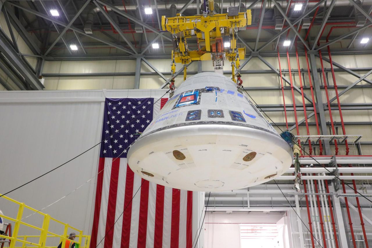 The Starliner crew module is hoisted in Boeing’s Commercial Crew and Cargo Processing Facility on January 19, 2023, before being mated to a new service module for NASA’s Boeing Crew Flight Test. 