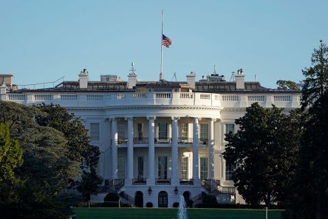 The American flag flies at half-staff above the White House on Saturday.