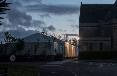 Night falls on a temporary morgue that has been constructed on the grounds of Haycombe Cemetery to accommodate victims of COVID-19 on May 1 in Bath, United Kingdom. 