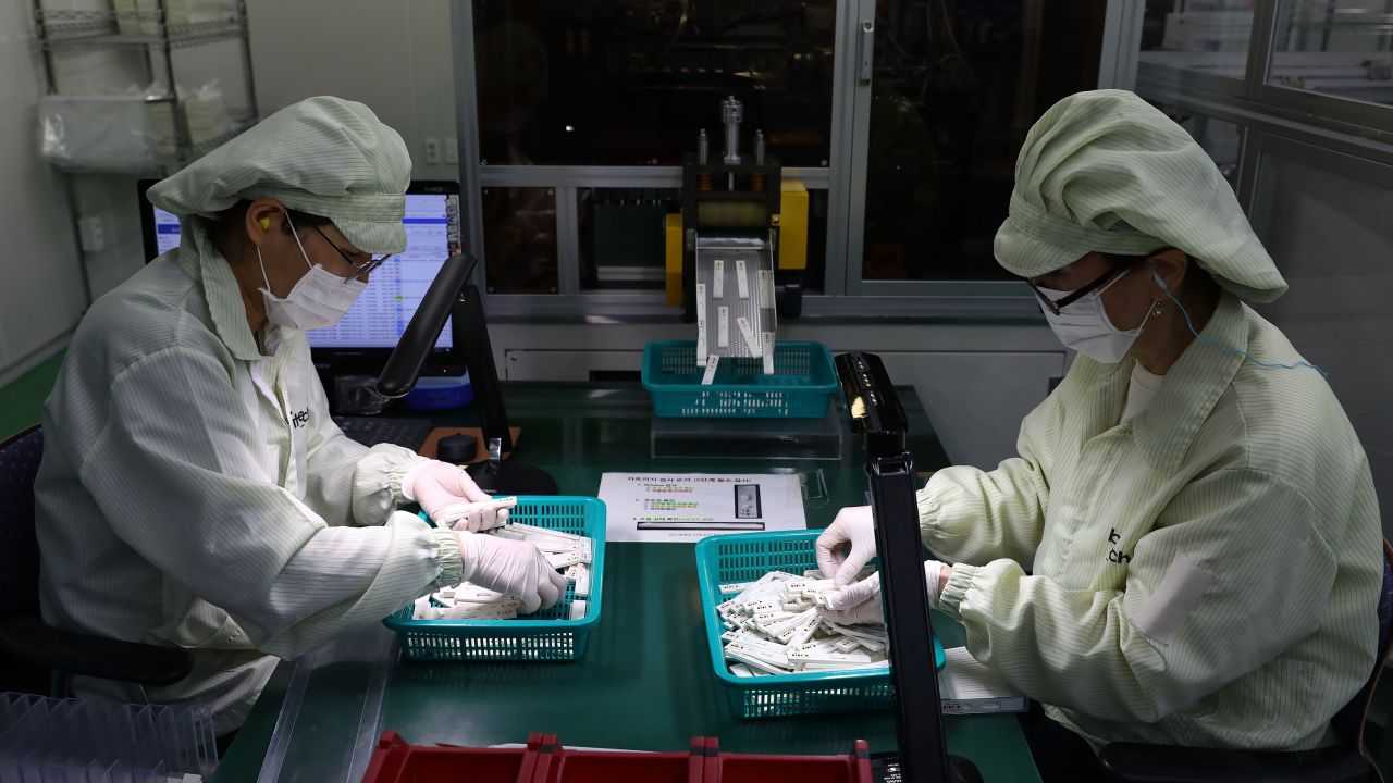Employees work on the production line of testing kits used in diagnosing the coronavirus at the Boditech Med Inc. headquarters in Chuncheon, South Korea on April 17. 