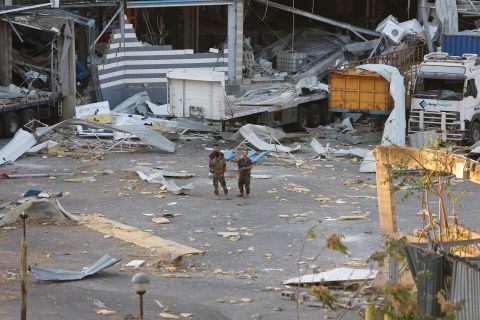 Military personnel stand amid debris on August 5, in Beirut, Lebanon.