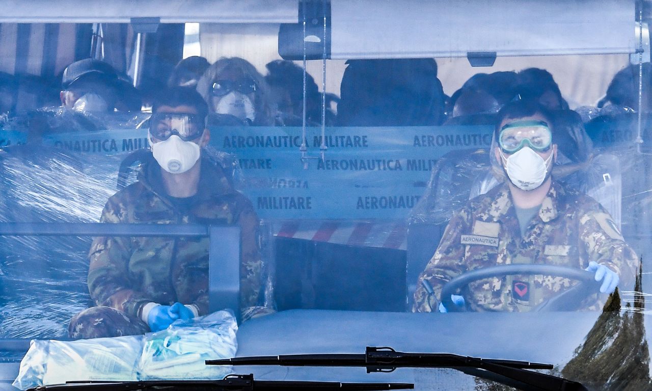 A military coach transporting Italian citizens repatriated from Wuhan leaves the Mario De Bernardi military airport in Pratica di Mare en route to the nearby Cecchignola center on February 3.