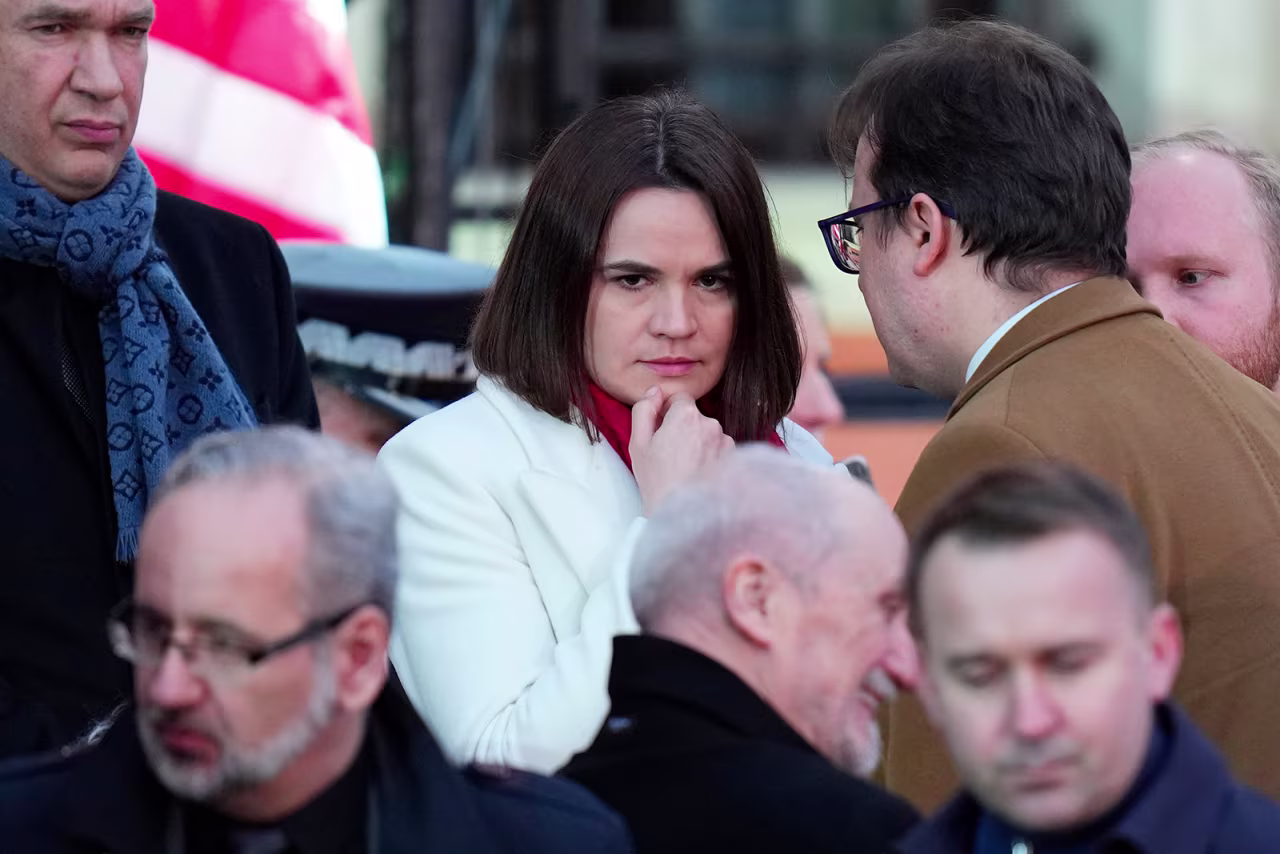 Belarusian opposition leader Sviatlana Tsikhanouskaya, center, waits for President Joe Biden to deliver a speech at the Royal Castle in Warsaw, Poland, Saturday, March 26.