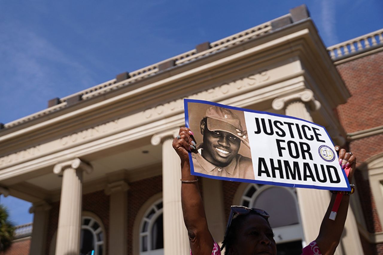 A demonstrator holding a sign at the Glynn County Courthouse on October 18, 2021 in Brunswick, Georgia when jury selection began. 