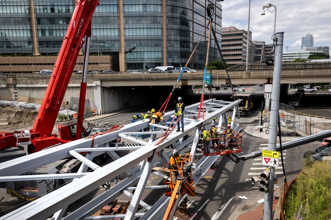 Workers prepare to lift a new pedestrian bridge into place at the Stamford Transportation Center in Stamford, Connecticut, on August 26.?