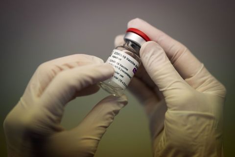 A pharmacist holds a vial of the AstraZeneca Covid-19 vaccine in Nantes, France, on March 25.