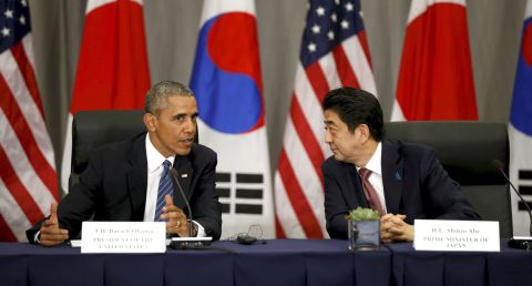 U.S. President Barack Obama, left, speaks to Japanese Prime Minister Shinzo Abe during their trilateral meeting with South Korean President Park Geun-Hye at the Nuclear Security Summit in Washington DC, on March 31, 2016.