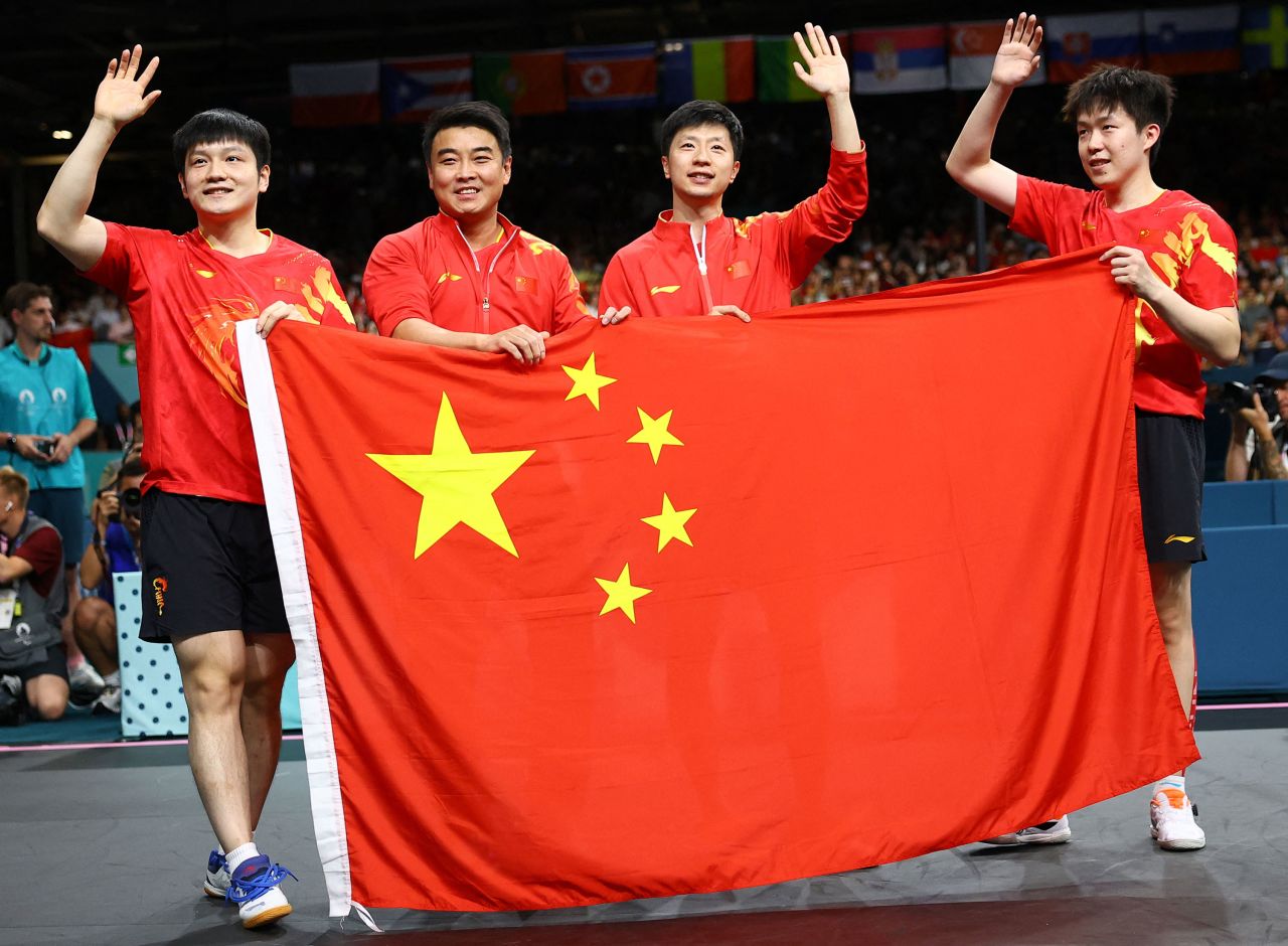 China's men's table tennis team celebrate after winning gold on Friday.