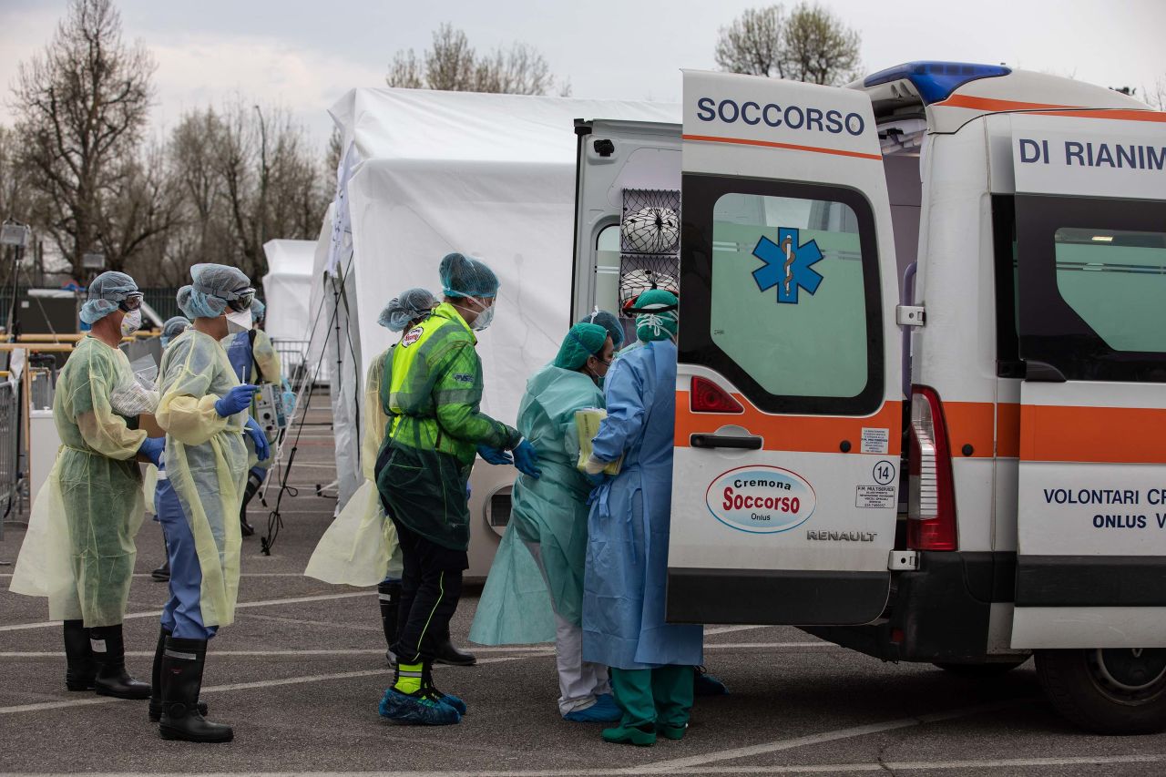 Medical personnel transport a coronavirus patient to a field hospital in Cremona, Italy, on March 20.