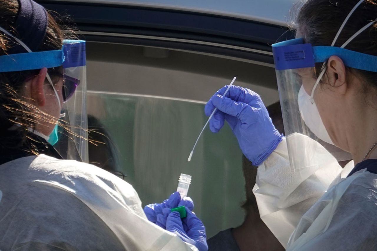 Medical professionals from Children's National Hospital administer a coronavirus test at a drive-thru testing site for children age 22 and under at Trinity University on April 2, in Washington.