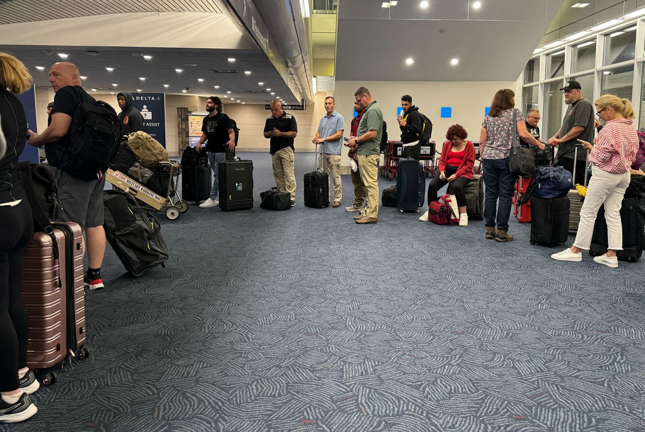 The Delta ticket counter is backed up at the Milwaukee Mitchell International Airport during a global ground stop on Friday, July 19.