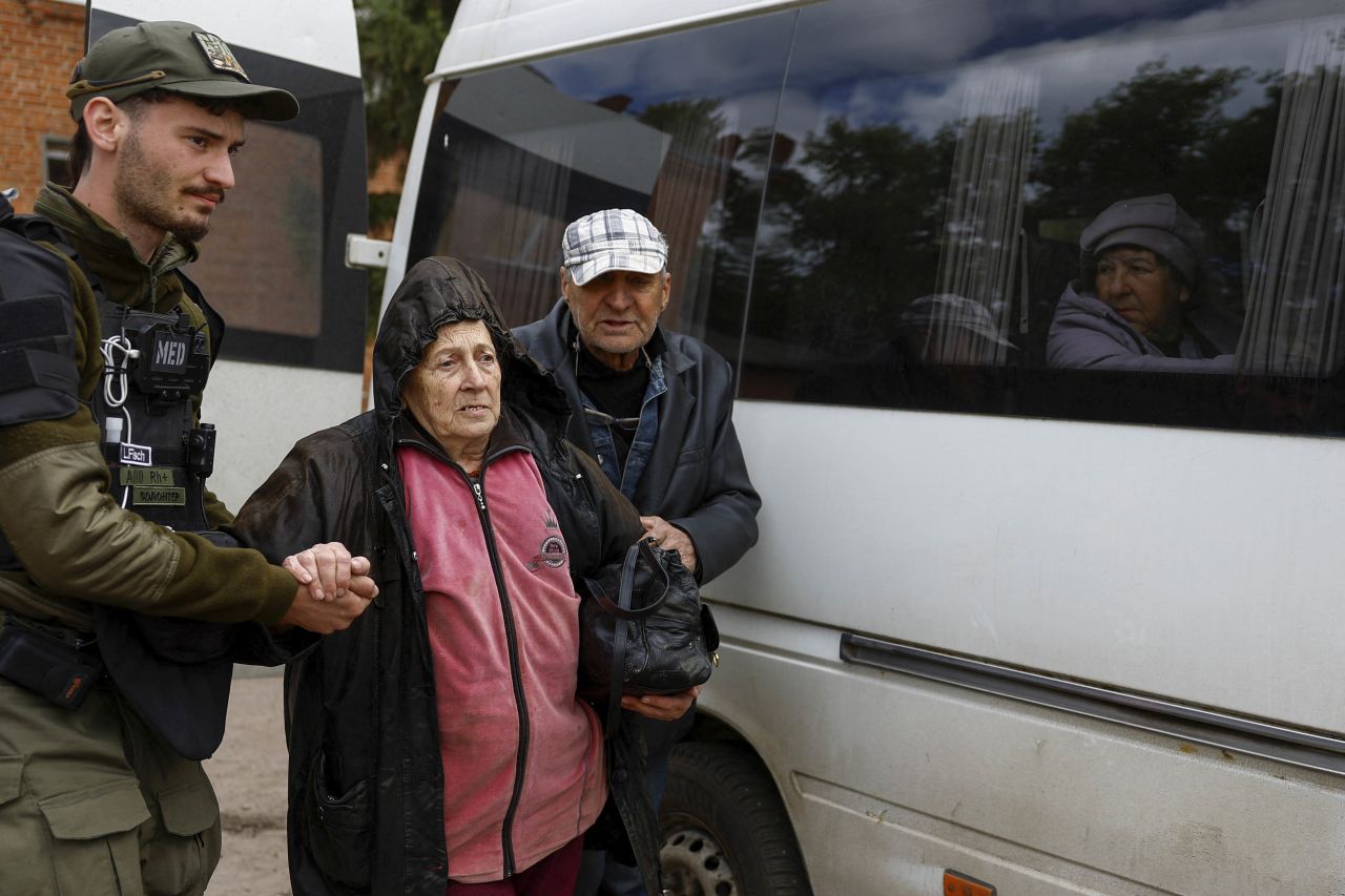 A volunteer assists an elderly couple from Vovchansk during their evacuation to Kharkiv, following Russian military strikes in the Kharkiv region, on May 14.