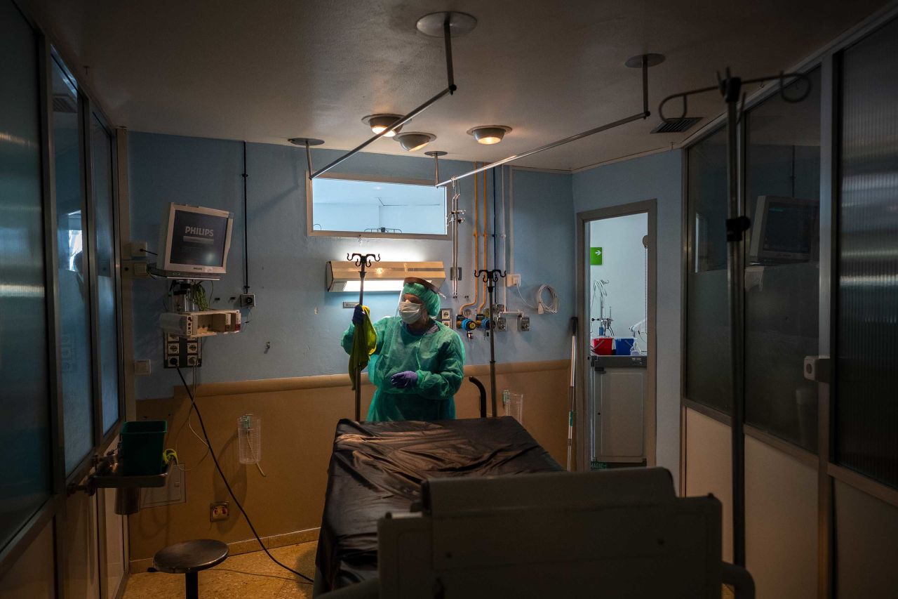 A member of hospital cleaning staff disinfects a room after a patient died at the Hospital Universitari de Bellvitge, near Barcelona, Spain, on April 9.