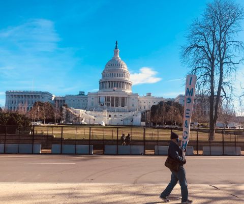 Bill Zawacki, 70, walks in front of the US Capitol on Saturday, January 9, in silent protest. He said he flew to Washington, DC, on Thursday from his home in Portland, Oregon, after seeing the violent attack on Congress.