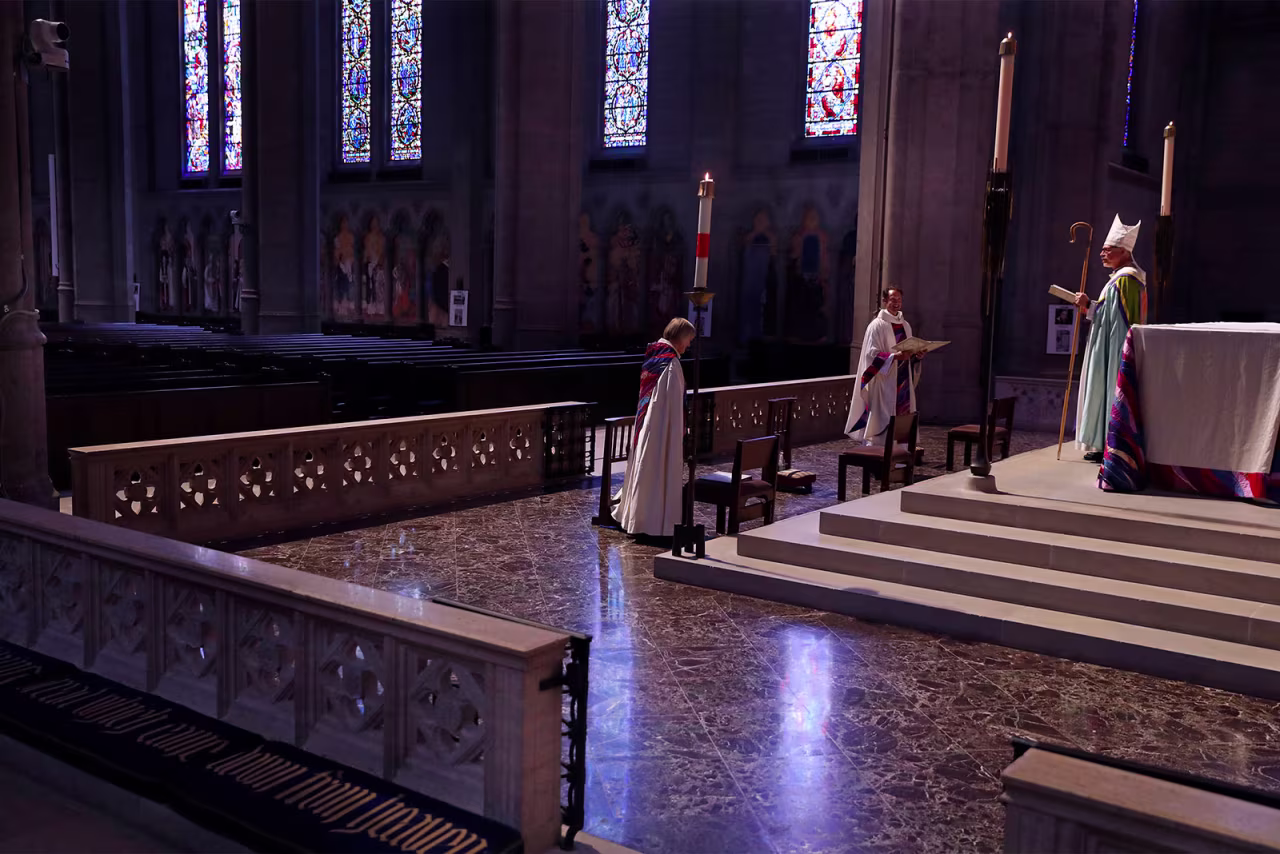 From left, Vice Dean Ellen Clark-King, Dean Malcolm Young and Bishop Marc Andrus conduct a virtual Easter Sunday service at an empty Grace Cathedral in San Francisco, California.