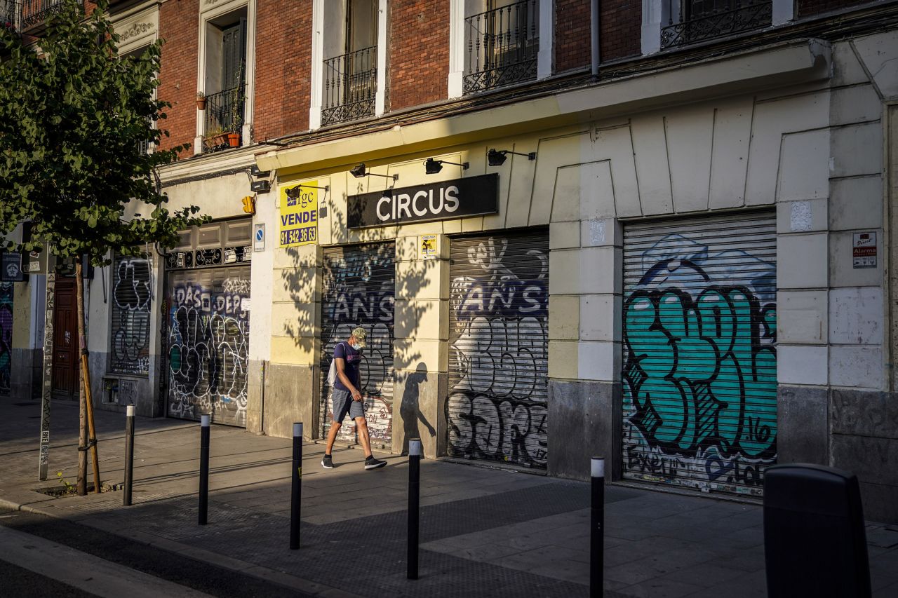 A person walks past shuttered businesses in Madrid on July 24.