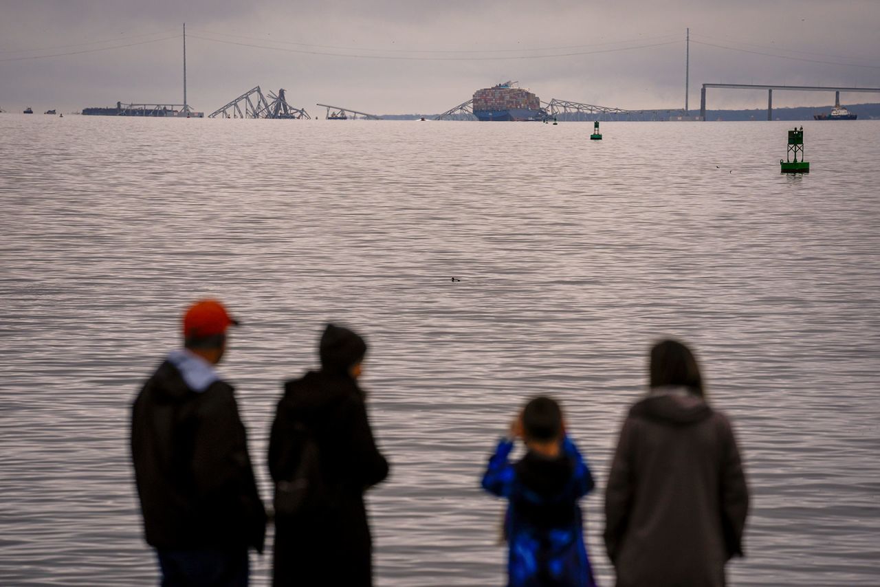 People view the collapsed Francis Scott Key Bridge on Wednesday, March 27, in Baltimore. 